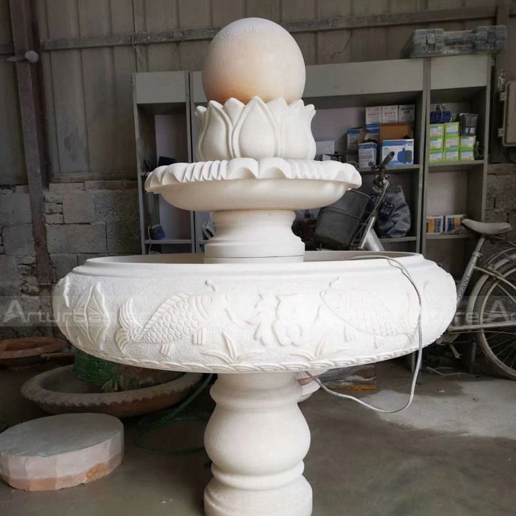 marble fountain with fish decoration