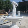 lady pouring water fountain