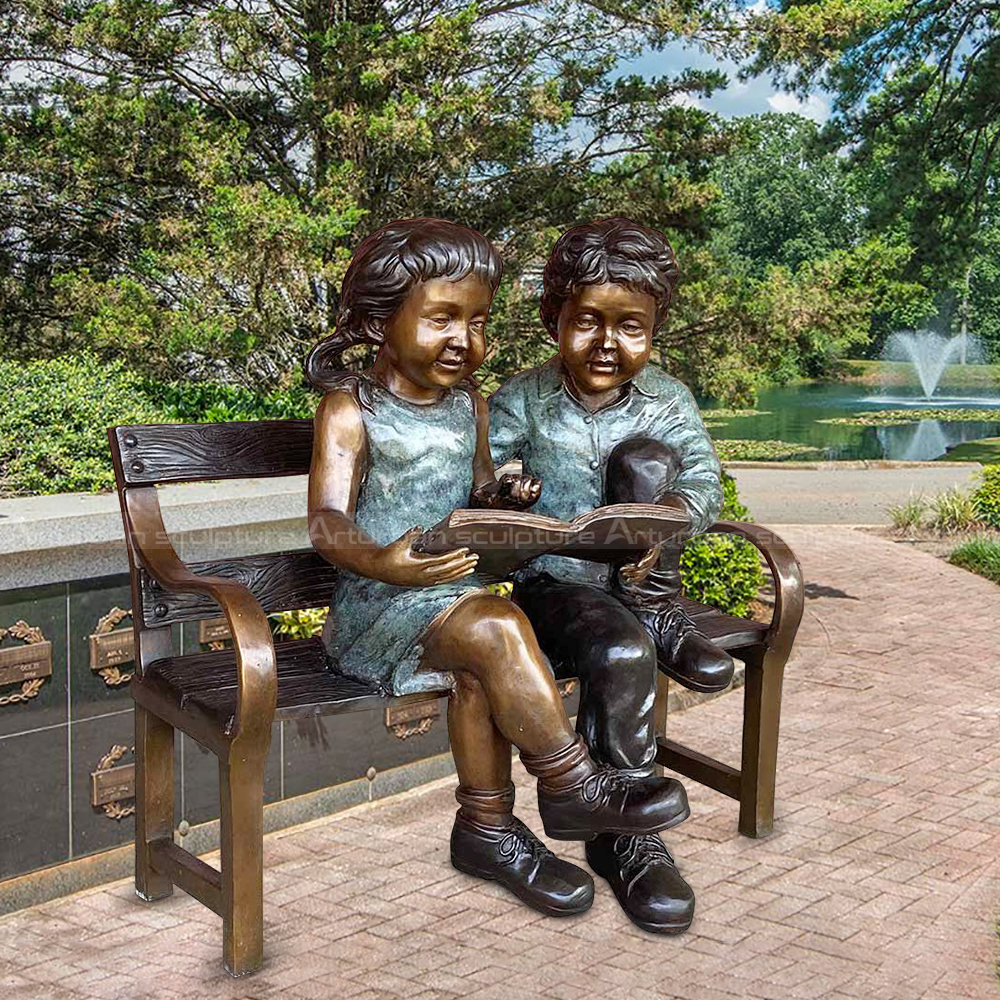 boy and girl reading garden statue