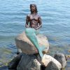 mermaid sitting on a rock statue