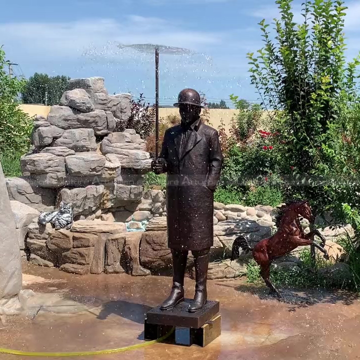 man statue with umbrella fountain