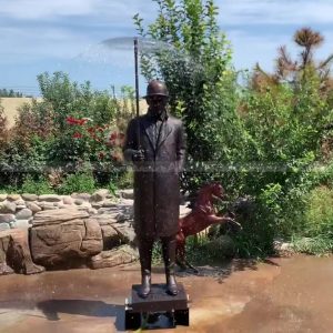 man statue with umbrella fountain