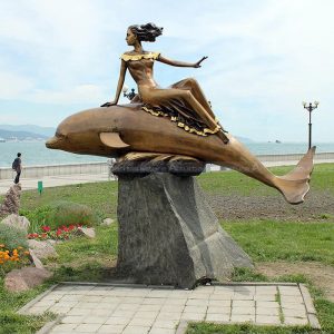 woman with dolphin statue