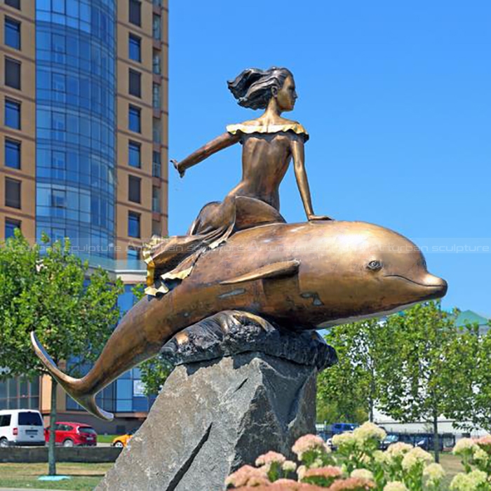 woman with dolphin statue