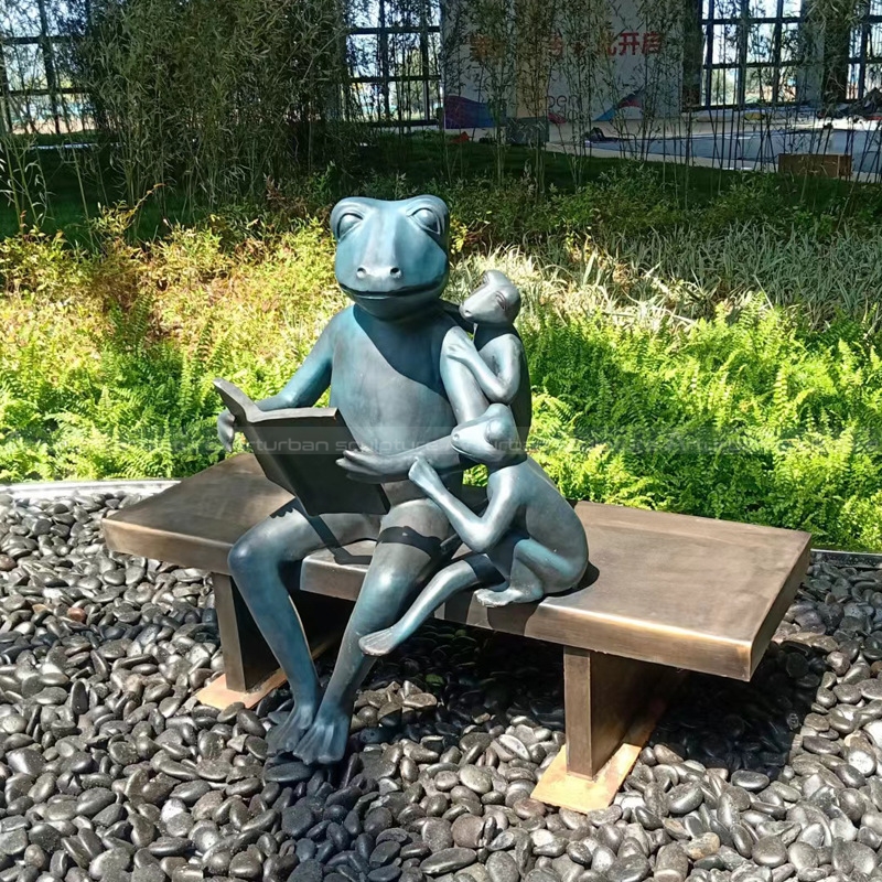 reading frog family garden sculpture