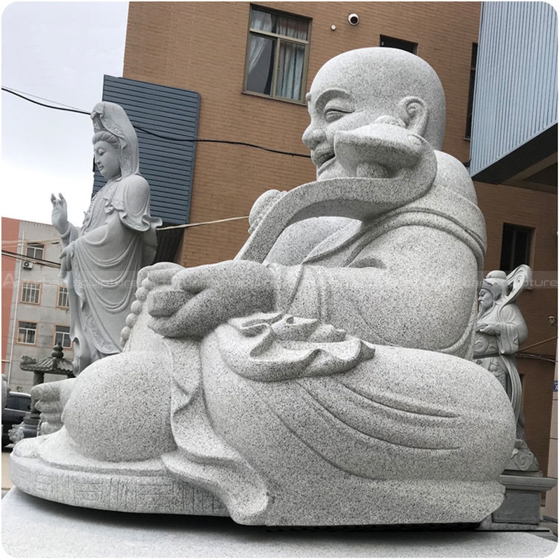 white laughing buddha statue