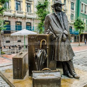 man with suitcase sculpture