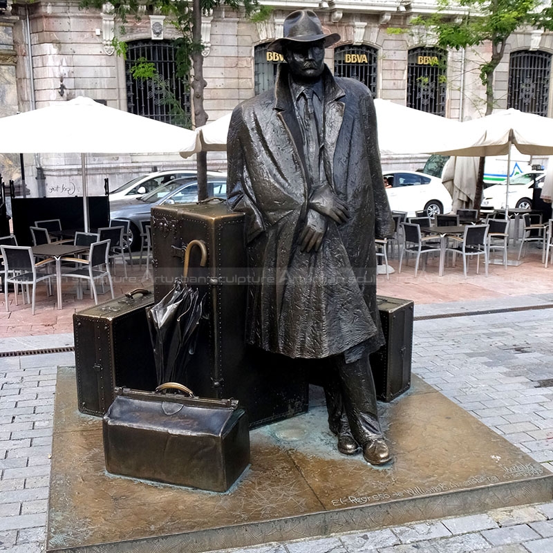 man with suitcase sculpture