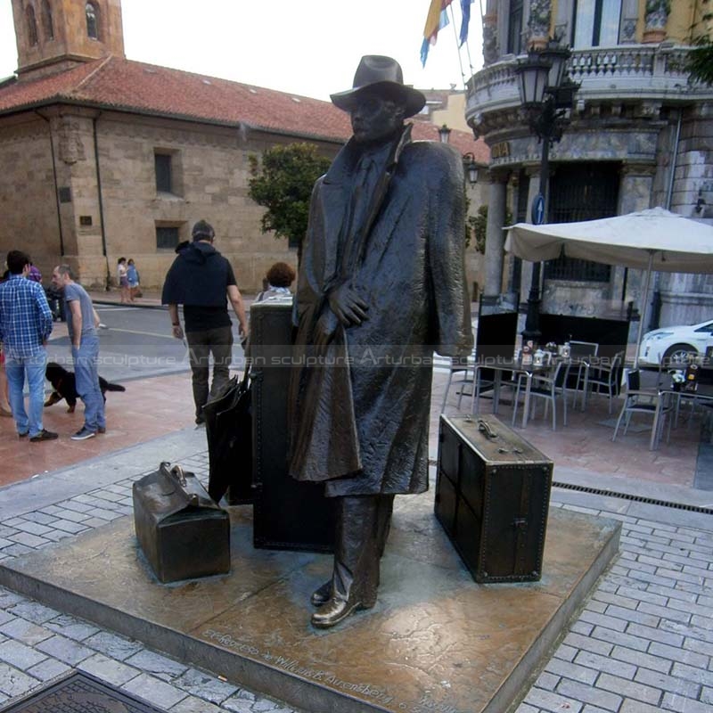 man with suitcase sculpture