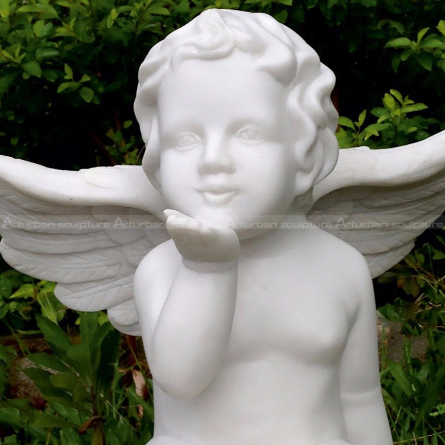 cherub on ball garden statue