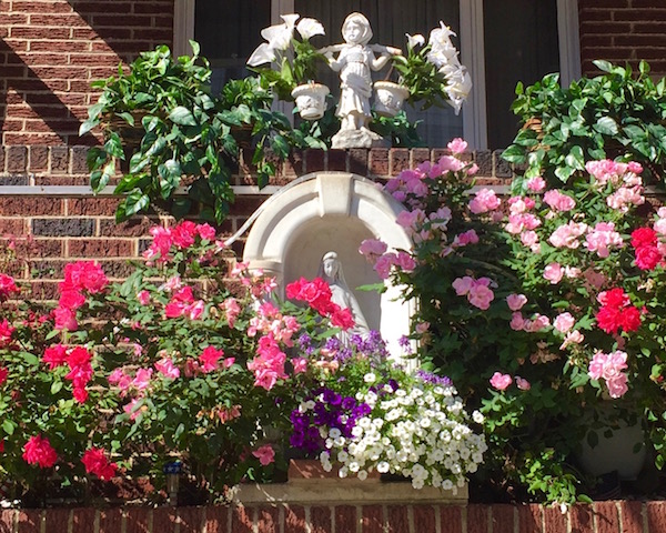 virgin mary statues in front of houses