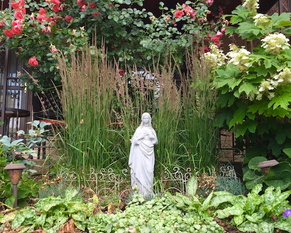 virgin mary statues in front of houses
