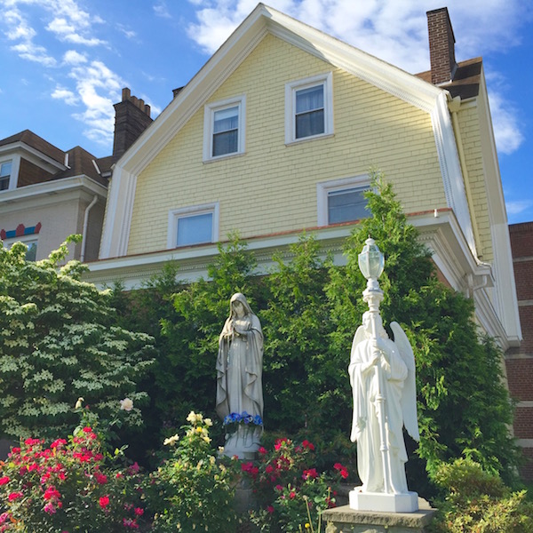 virgin mary statues in front of houses