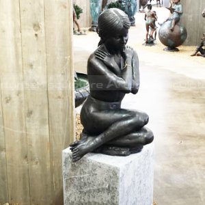 nude lady sitting statue
