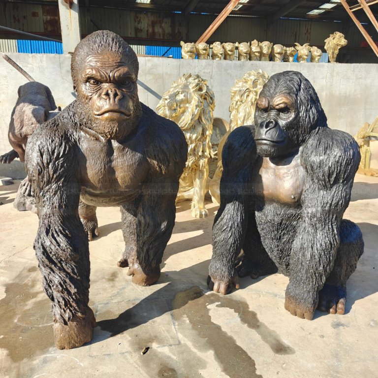 Gorilla Statue Life Size, one in a standing pose and another one in a crouching pose