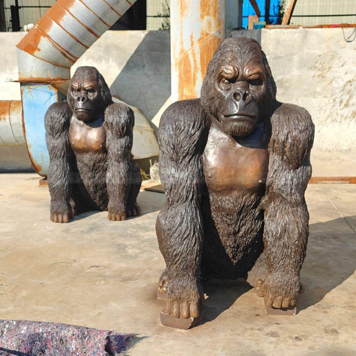 Two Gorilla Statues Life Size in a crouching position