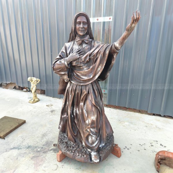 bronze Nun Sculpture with a raised hand