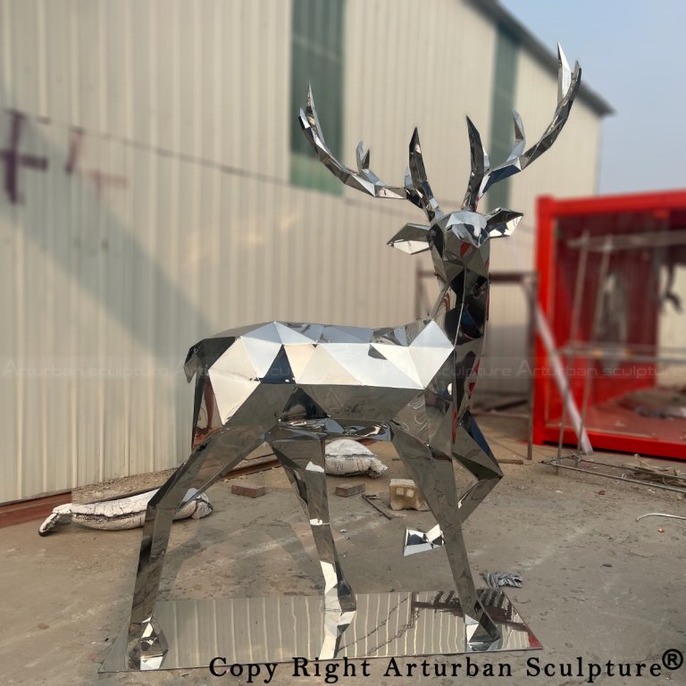 stainless steel low-poly deer statue showing one front leg slightly raised
