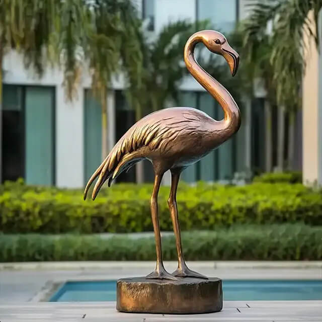 Bronze Flamingo Sculpture standing gracefully in a garden