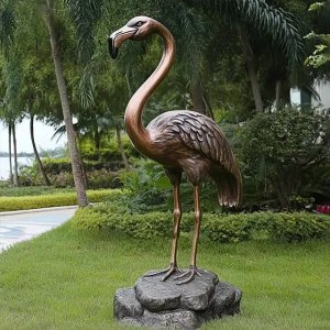 Bronze Flamingo Sculpture standing on rock with vivid detailed feathers