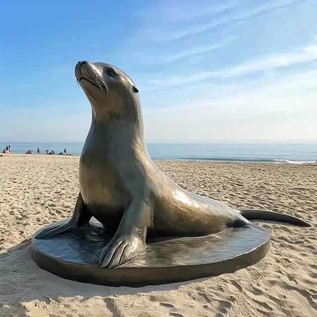 Bronze Sea Lion looking up sculpture with round base
