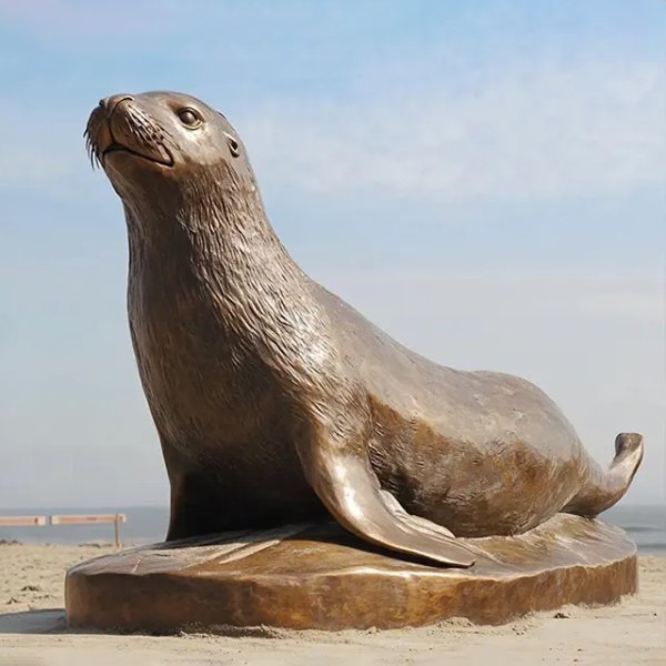 Bronze Sea Lion statue lying on the base