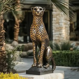 Cheetah Sitting on a base Sculpture showcasing its slender body, muscular legs, and detailed spots.