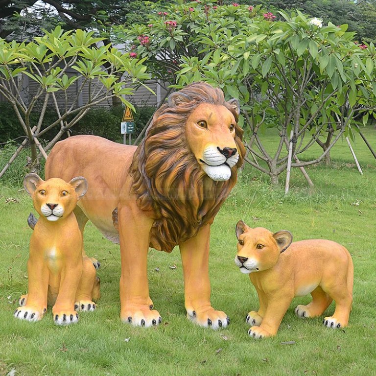 Garden Lions Sculptures showing one adult lion with two cubs on green grass land