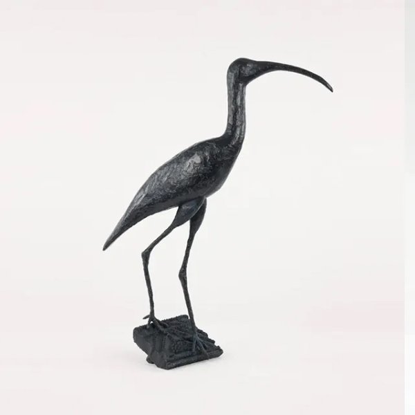 Ibis Sculpture elegantly standing with its long curved beak and slender legs