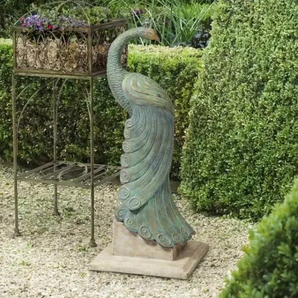 Peacock Decor Statue featuring the peacock looking backward with a gracefully curved tail