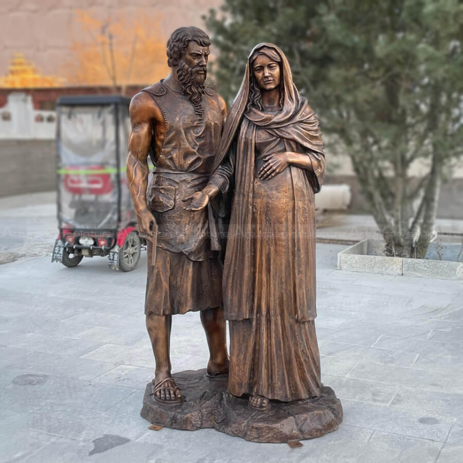 Saint Joseph gently supporting the pregnant virgin Mary Statue