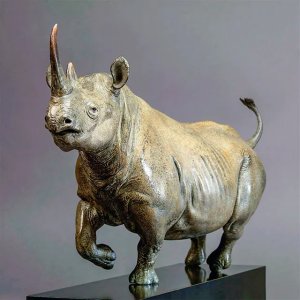 bronze Black Rhino Sculpture by Nick Bibby, depicting the animal in a dynamic running pose with detailed muscle lines
