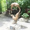 bronze Otter Garden Sculpture depicting two swimming otters, one above the other, both focused on the same point ahead