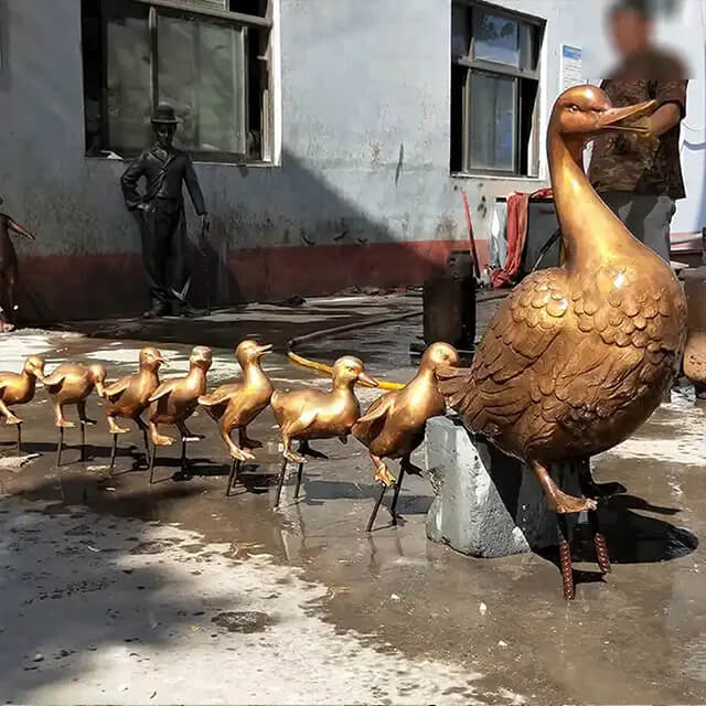 bronze Statue of Make Way for Ducklings featuring mother duck leading her ducklings