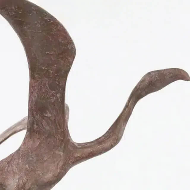 close up of bronze Contemporary Bird Figurine showcasing the bird's extended wings, curved neck,