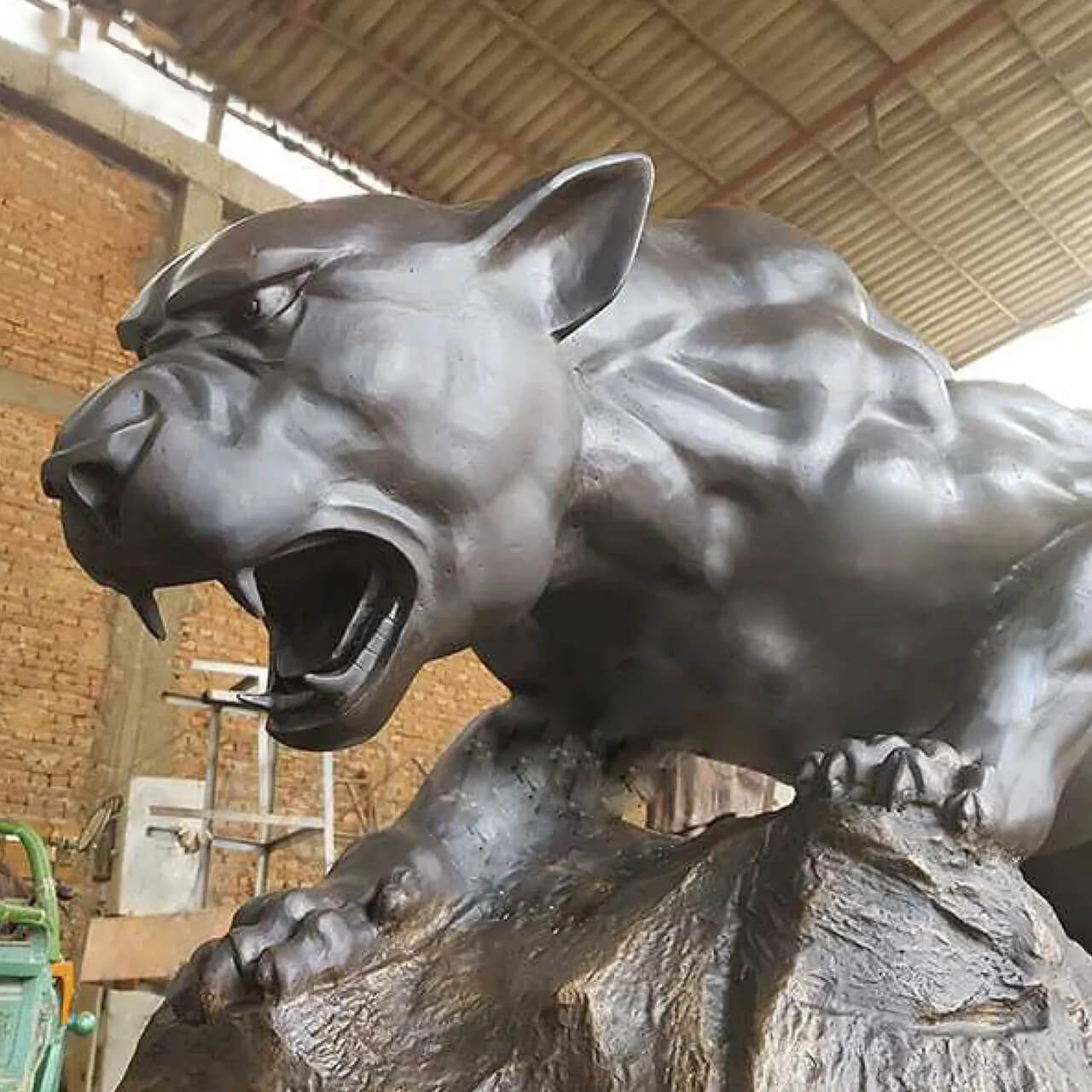 close up view of Panther Bronze Statue's head with roaring expression