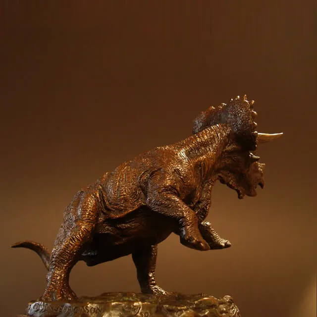 side view of bronze Triceratops Sculpture showing muscular build and skin texture
