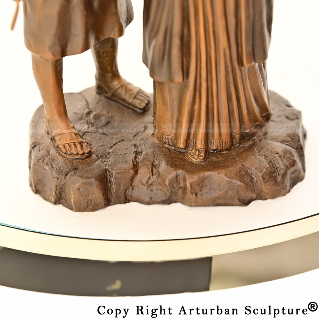 Close-up of feet on the statue base, showing textured rocky ground