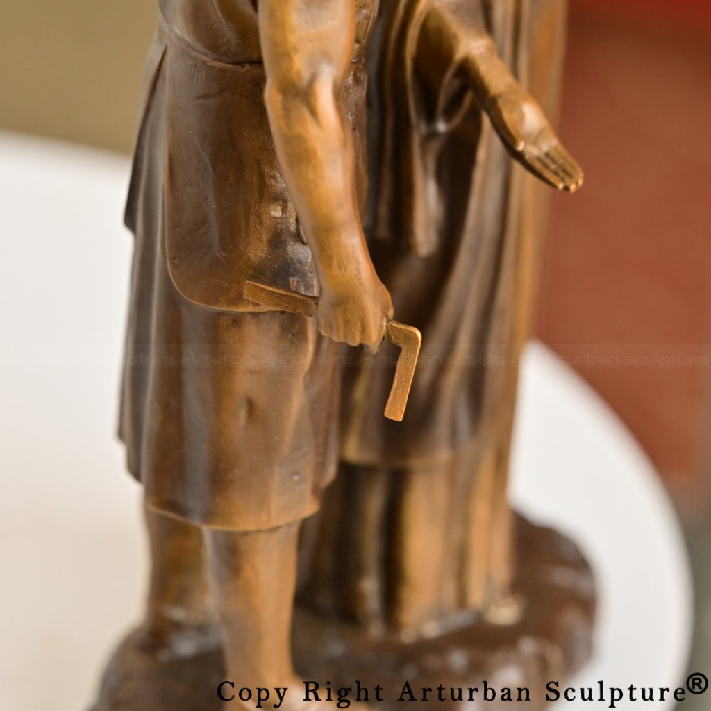 bronze Joseph holding a small carpenter’s square in his right hand