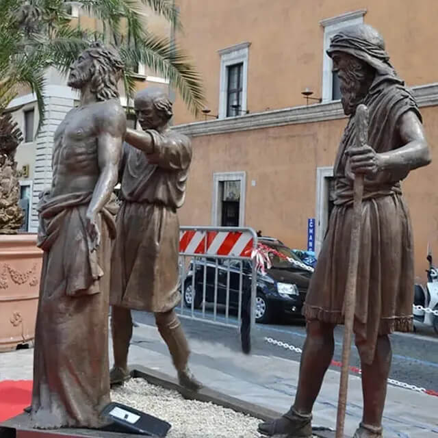 Bronze Stations of the Cross Sculpture showing Jesus being stripped of His garments