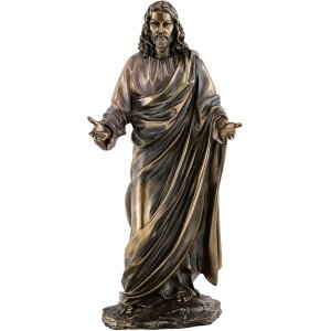 Bronze statue of Jesus with open arms, draped in flowing robes and standing in a peaceful posture