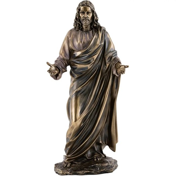 Bronze statue of Jesus with open arms, draped in flowing robes and standing in a peaceful posture