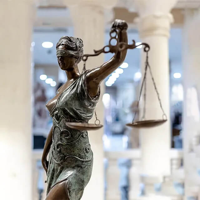 Close-up of a bronze Statue of Blindfolded Lady holding balanced scales