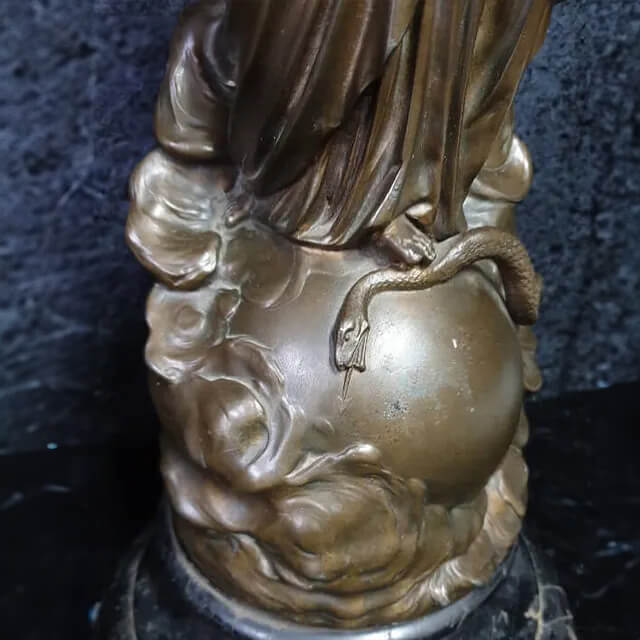 Close-up of the base of a Madonna and Child Sculpture