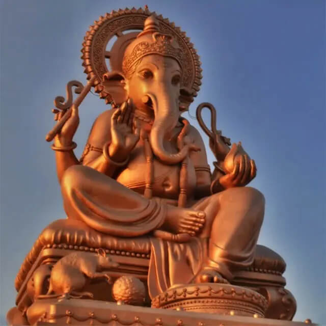 Copper-toned Lord Ganesha Sculpture seated on an embellished base with mouse figure below