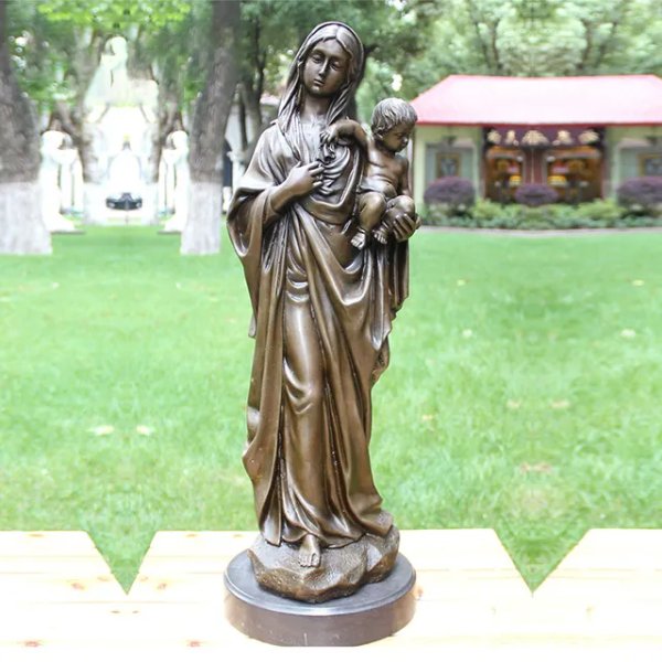 Full-length bronze sculpture of Mother Mary holding baby Jesus gracefully