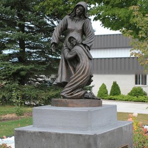 Full view of a bronze Visitation Statue depicting the biblical encounter between Mary and Elizabeth