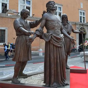 Outdoor bronze Stations of the Cross Sculpture depicting the tenth station