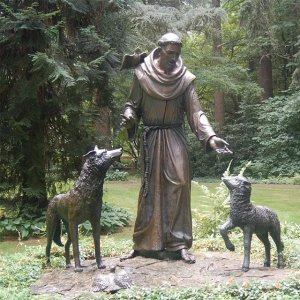 St Francis of Assisi Statue with Animals standing peacefully in a forest garden