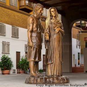 bronze Mary and Joseph Sculpture showing saint joseph standing next to pregnant mary